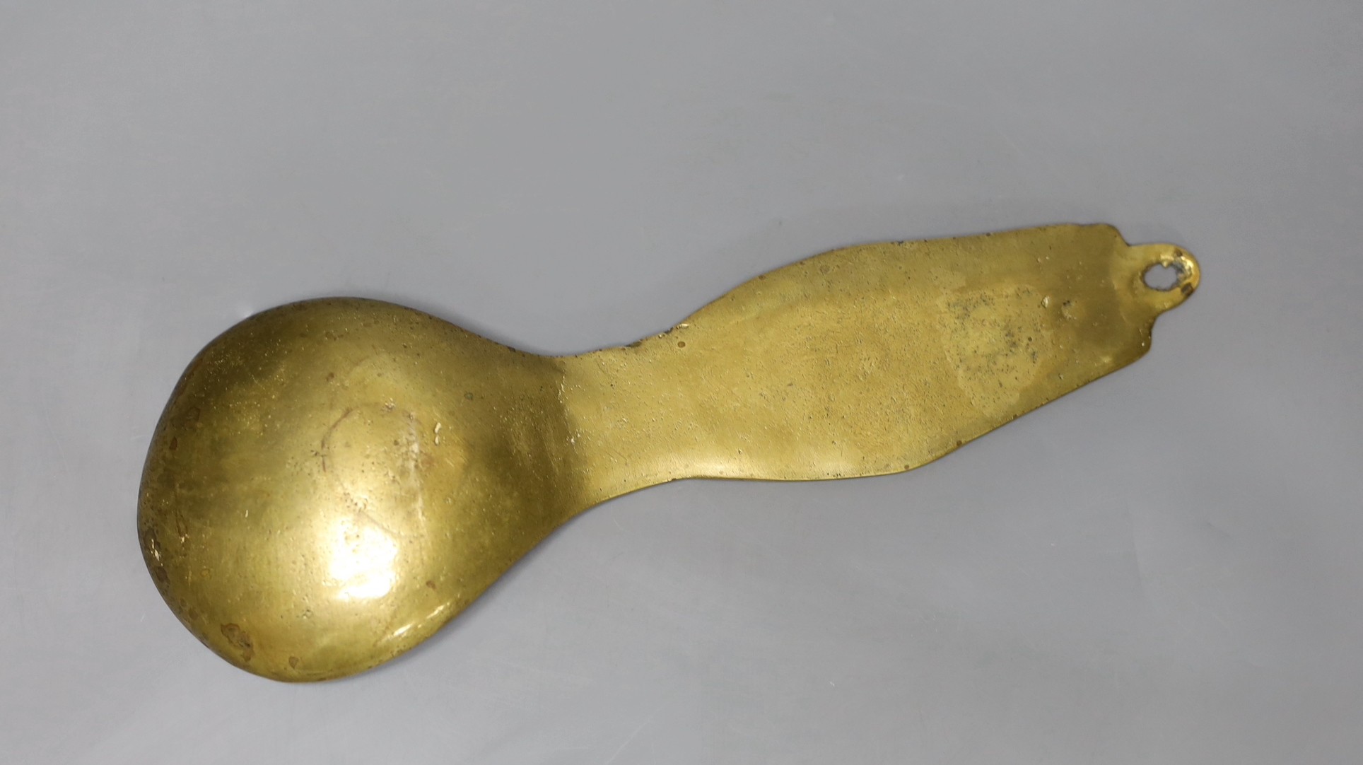 A folk art cast brass ladle, 27cms long